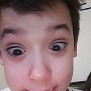 Tyler joined the competition — help win amazing prizes! child, face, close_up, expression, eyes, mouth, hair, shirt, playful, portrait, indoor, person, young, skin, eyebrows, teeth, funny, casual, smile, wide_eyes