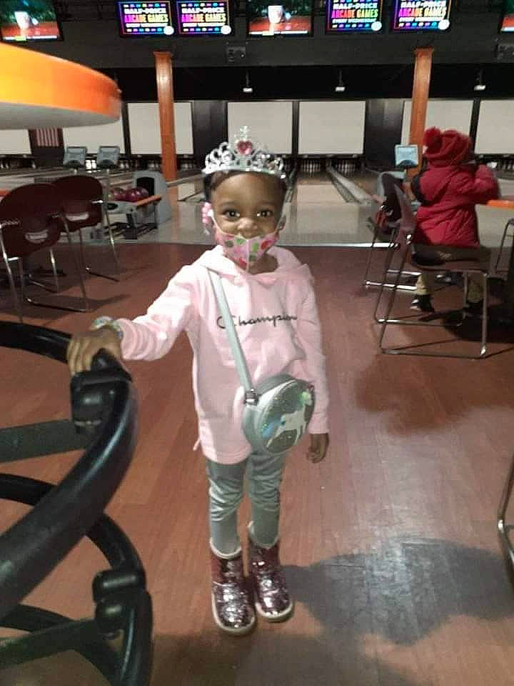 Aubrielle is registered to the contest to win money with this photo: boot, chair, child, entertainment, event, fashion_design, flooring, fun, leisure, machine, person, recreation, room, sitting, smile, standing, t_shirt, television, toddler