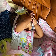 Mavie Kaehna a rejoint le concours — aidez-le/la à gagner de superbes lots ! toddler, child, easter, tutu, flower_headband, blanket, couch, leather, colorful, clothing, baby, hand, face_covering, soft_toys, pink, blue, yellow, pattern, indoor, resting