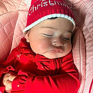 Paytom joined the competition — help win amazing prizes! baby, infant, sleeping, christmas_hat, red_clothing, pink_blanket, quilted_seat, face, cheeks, lips, closed_eyes, pom_pom, knit_hat, earring, sunlight, cozy, holiday, portrait, hands, cute
