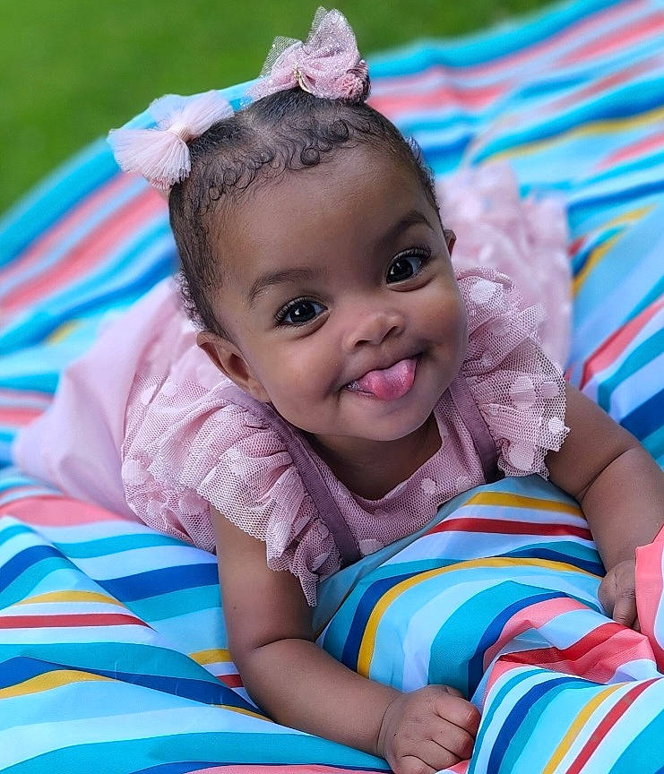 Wynter joined the competition — help win amazing prizes! arm, baby, baby_toddler_clothing, blue, child, comfort, eye, fashion_accessory, fun, grass, happy, headpiece, joy, leisure, person, pink, play, recreation, sitting, skin