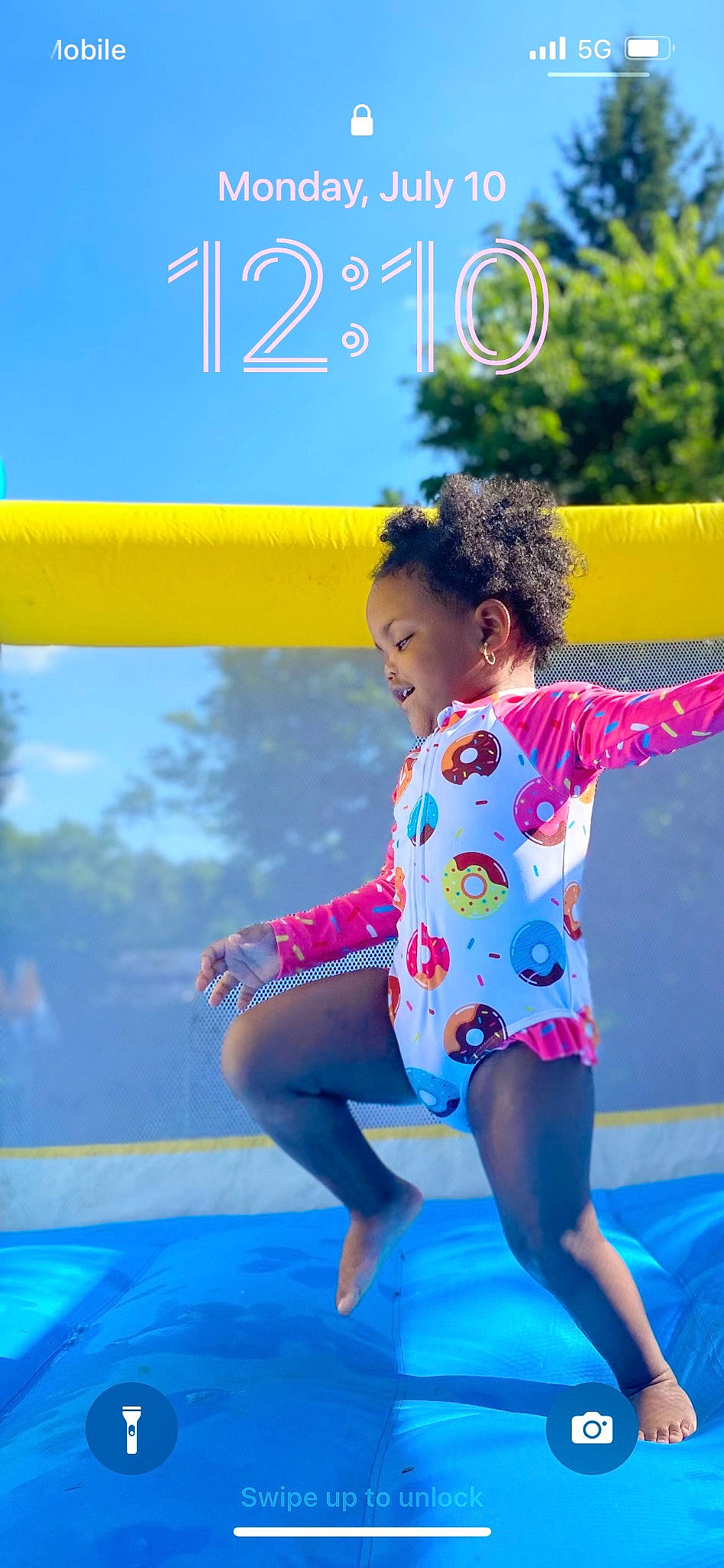 Harley is registered to the contest to win money with this photo: barefoot, electric_blue, entertainment, fun, happy, leg, leisure, morning, people_in_nature, person, playground, public_space, recreation, sky, smile, summer, t_shirt, thigh, trampolining_equipment_and_supplies, tree