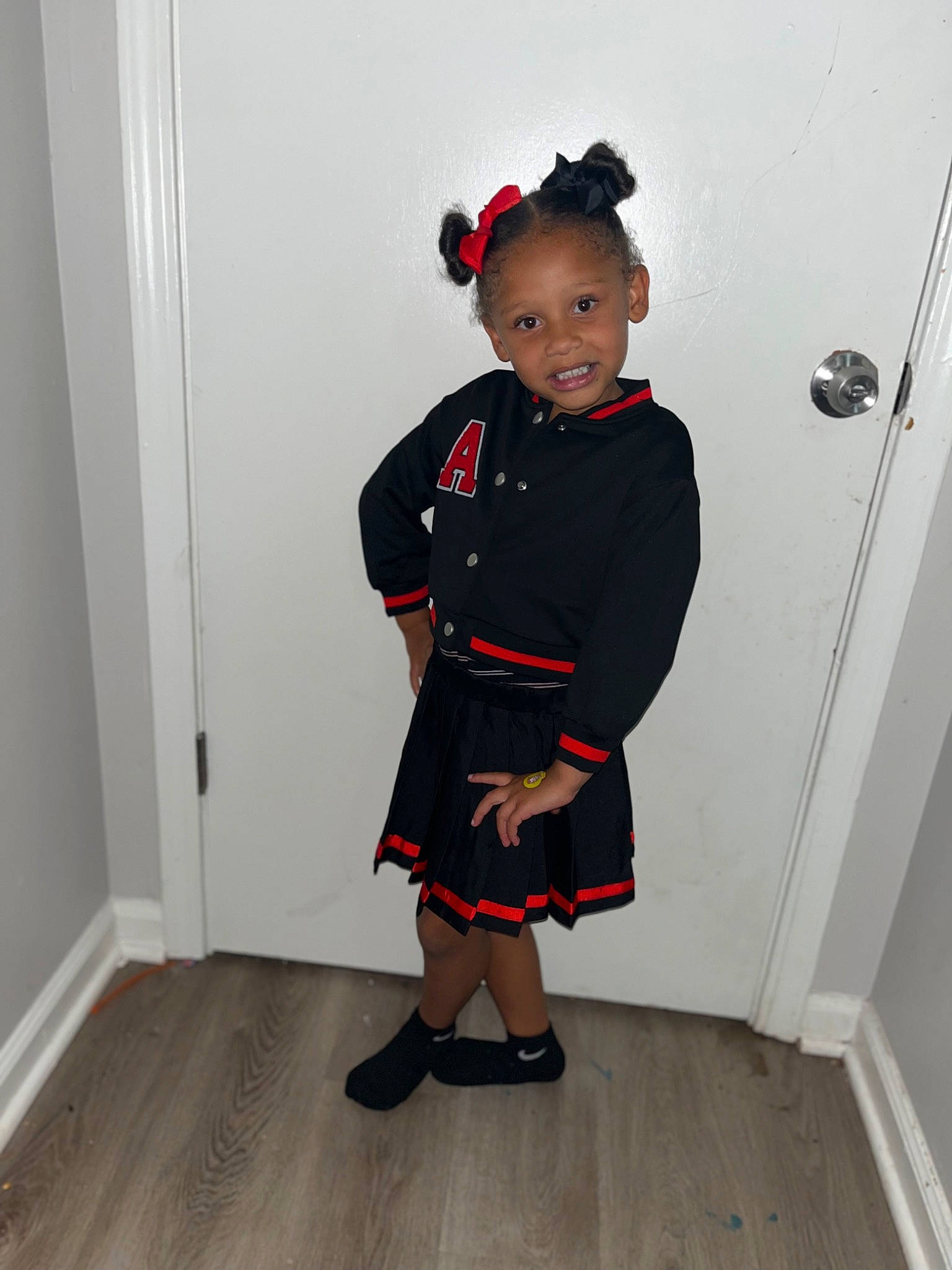 Harley is registered to the contest to win money with this photo: child, collar, costume, event, fashion_design, flooring, formal_wear, happy, hardwood, joy, knee, leg, pattern, person, room, sleeve, sock, standing, toddler, uniform