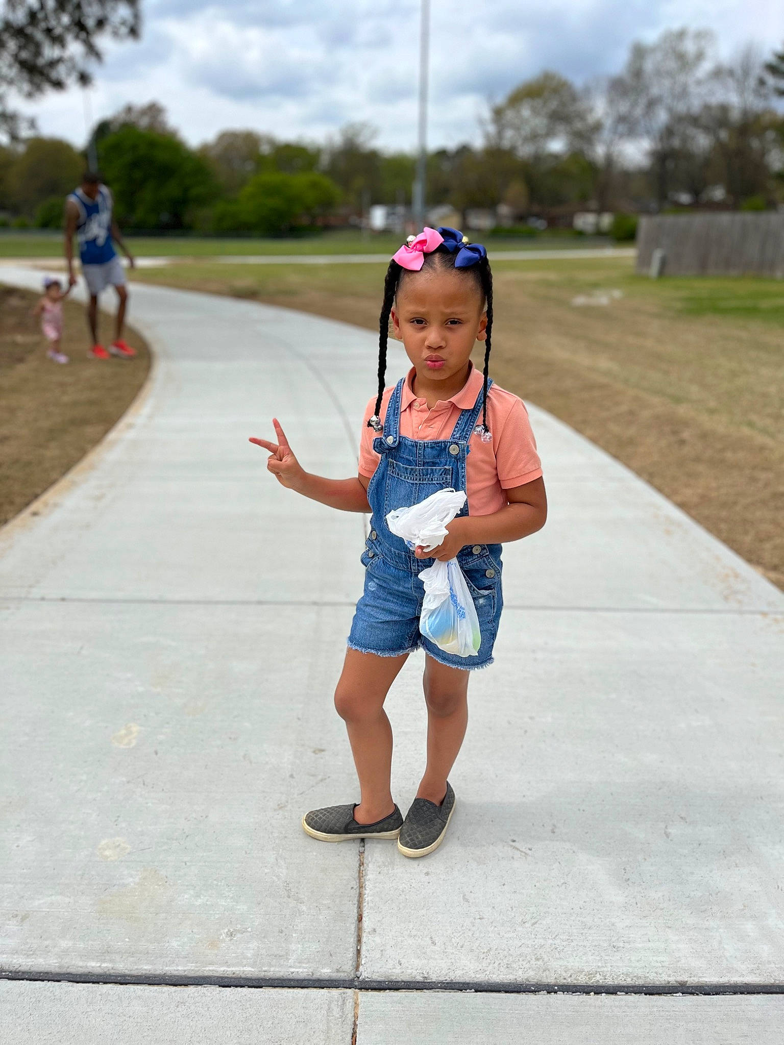 Harley joined the competition — help win amazing prizes! asphalt, child, cloud, denim, electric_blue, fashion_accessory, fun, grass, happy, headwear, leisure, pattern, pedestrian, person, plant, recreation, road, sidewalk, sky, toddler