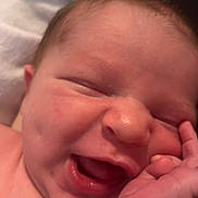 Jacob is registered to the contest to win money with this photo: baby, bodypart, face, finger, hand, happy, head, laughing, mouth, newborn, person, photography, portrait