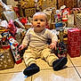 Léo a rejoint le concours — aidez-le/la à gagner de superbes lots ! baby, child, presents, gifts, christmas, holiday, floor, tile, wrapped_gifts, sitting, indoors, cute, winter, festive, celebration, clothing, shoes, face, person, surprise