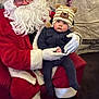 baby, child, santa_claus, hat, bear_hat, glasses, beard, red_suit, white_gloves, chair, indoor, holiday, christmas, decoration, tinsel, person, portrait, cute, festive, seated
