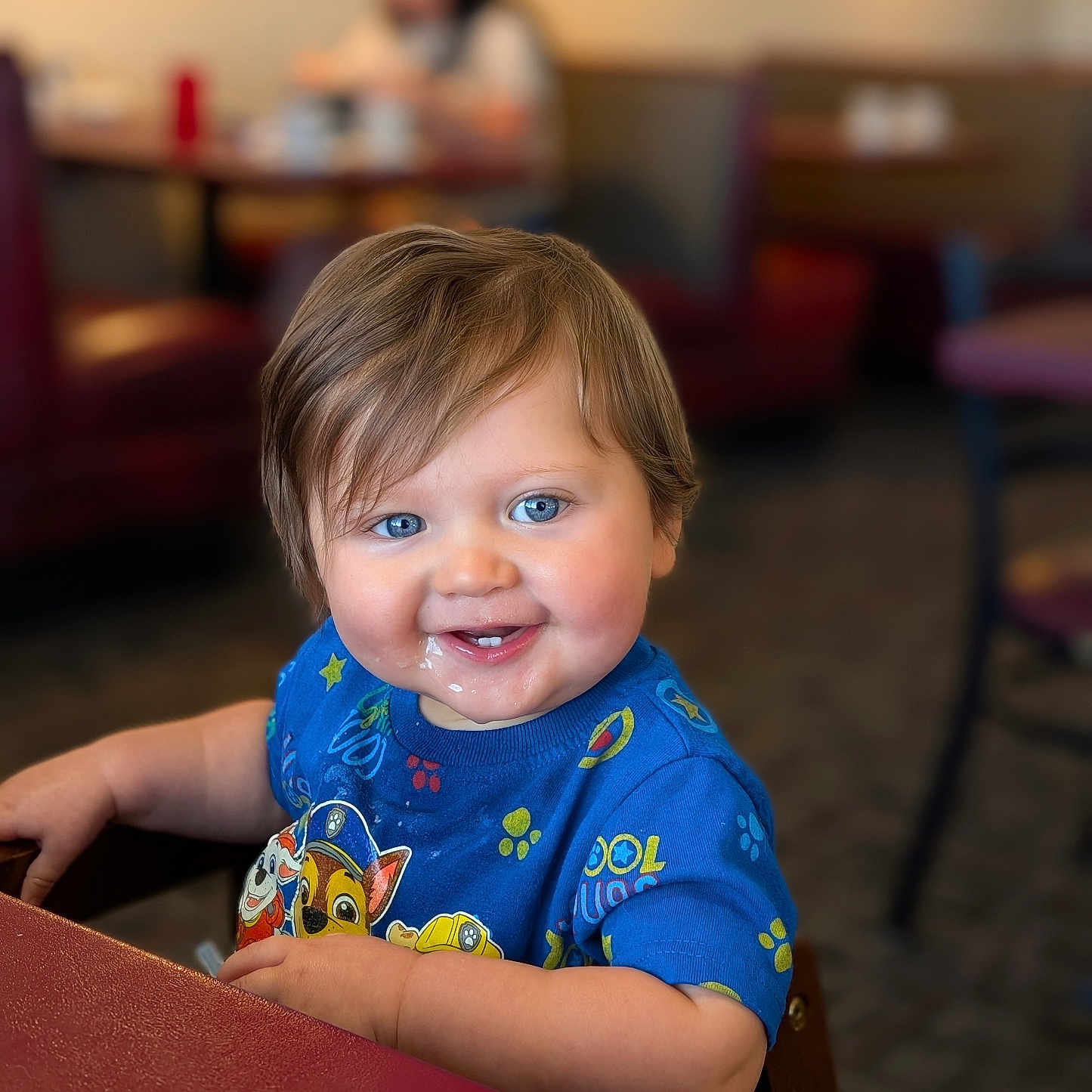Elrey joined the competition — help win amazing prizes! blue_eyes, casual_clothing, chair, child, cute, family, food, happy, indoor, meal_time, messy_face, paw_patrol_shirt, person, portrait, restaurant, seated, short_hair, smiling, table, toddler