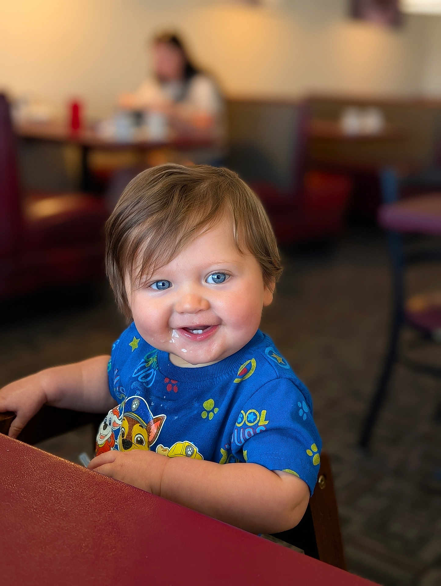 Elrey joined the competition — help win amazing prizes! toddler, child, blue_eyes, smiling, messy_face, paw_patrol_shirt, short_hair, indoor, restaurant, table, chair, happy, cute, person, portrait, seated, food, meal_time, casual_clothing, family
