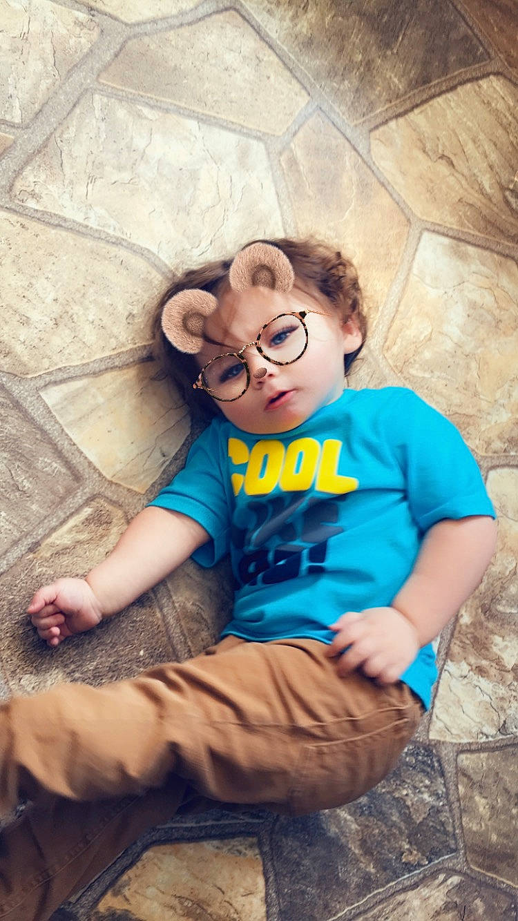 Corbyn is registered to the contest to win money with this photo: child, cool, eyewear, fun, glasses, happy, leg, person, photography, sitting, smile, sunglasses, t_shirt, toddler, vacation, vision_care