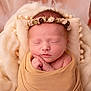 newborn, baby, sleeping, wrapped, blanket, headband, flower_crown, soft_texture, cushion, cream_color, beige, peaceful, portrait, infant, cute, hands, closed_eyes, skin, indoors, rest
