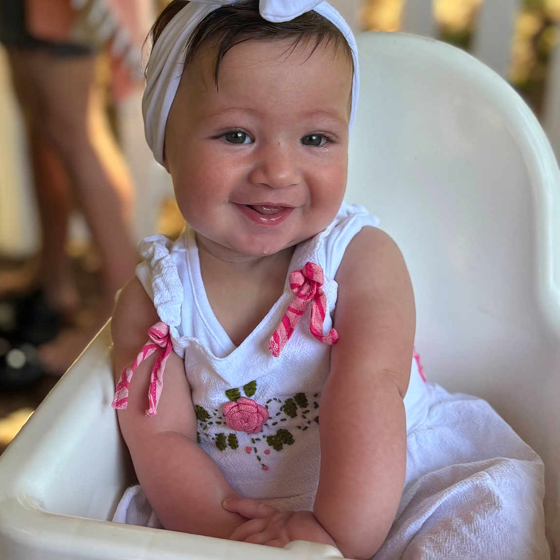 Sophia is registered to the contest to win money with this photo: baby, background_blur, bow, child, cute, face, hair, happy, headband, high_chair, indoor, infant, person, pink_ribbons, portrait, seated, skin, smile, toddler, white_dress
