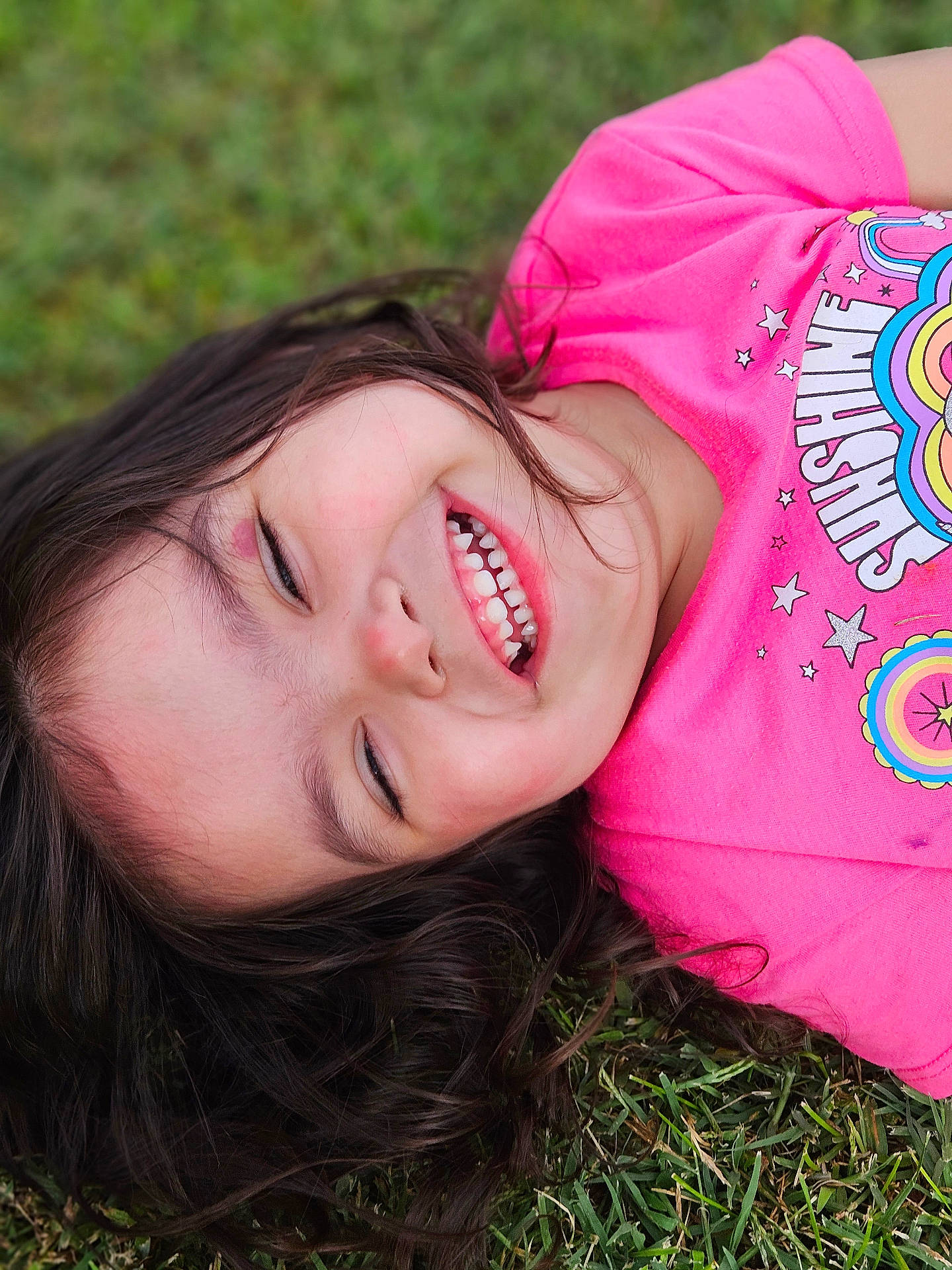 Kailani joined the competition — help win amazing prizes! bodypart, child, clothing, face, female, girl, grass, happy, head, laughing, lawn, mouth, person, photography, plant, portrait, shirt, smile, t_shirt, teeth