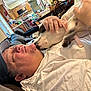 Mortisha joined the competition — help win amazing prizes! man, dog, tattoo, cap, white_shirt, indoor, kitchen, dining_table, chair, pet, licking, hand, collar, casual, relaxing, smiling, closeup, comfort, home, affection
