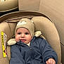 baby, child, car_seat, hat, knitted_hat, blue_jacket, smile, tongue_out, cozy, indoor, cute, face, infant, apparel, warm_clothing, seat, person, young_child, closeup, happy