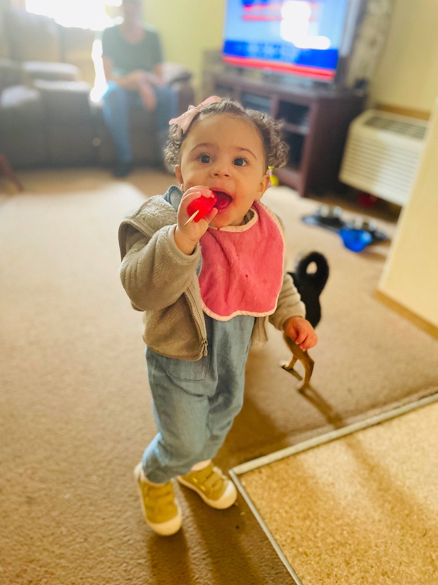Kamaya is registered to the contest to win money with this photo: baby, baby_toddler_clothing, child, face, floor, flooring, fun, happy, hardwood, home_appliance, human_leg, leisure, person, sitting, skin, standing, surprise, television, toddler, toy