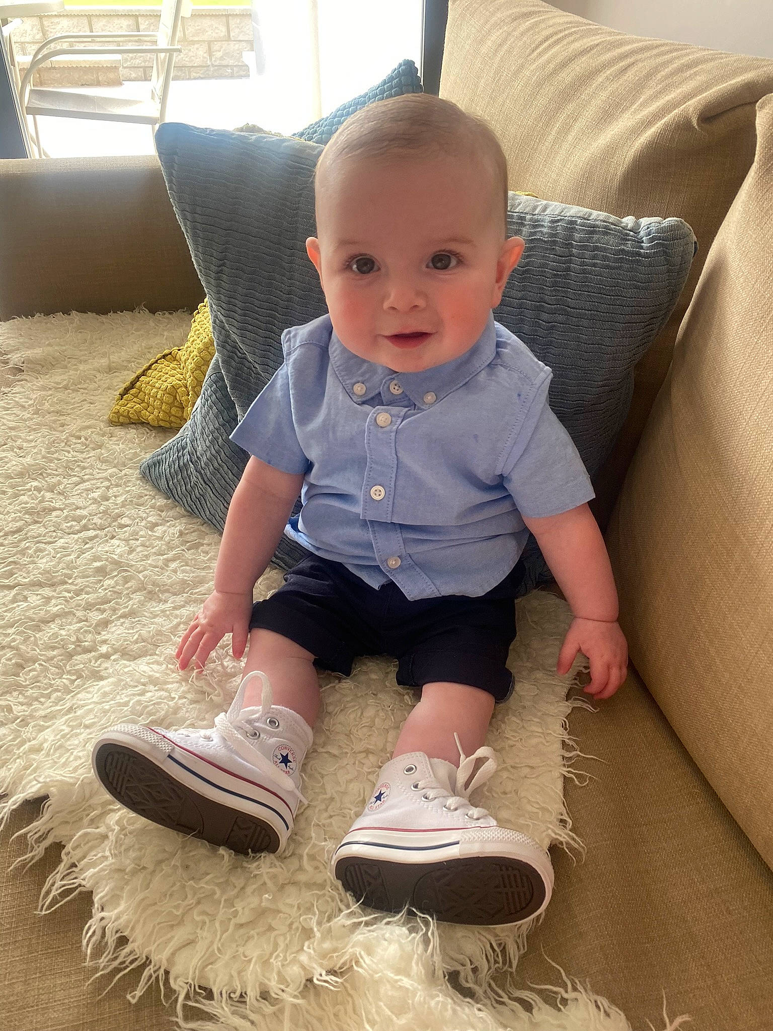 Blair joined the competition — help win amazing prizes! baby_toddler_clothing, chair, comfort, couch, eye, face, floor, flooring, footwear, grass, leg, outdoor_shoe, person, shoe, shorts, sleeve, smile, sneakers, toddler, walking_shoe