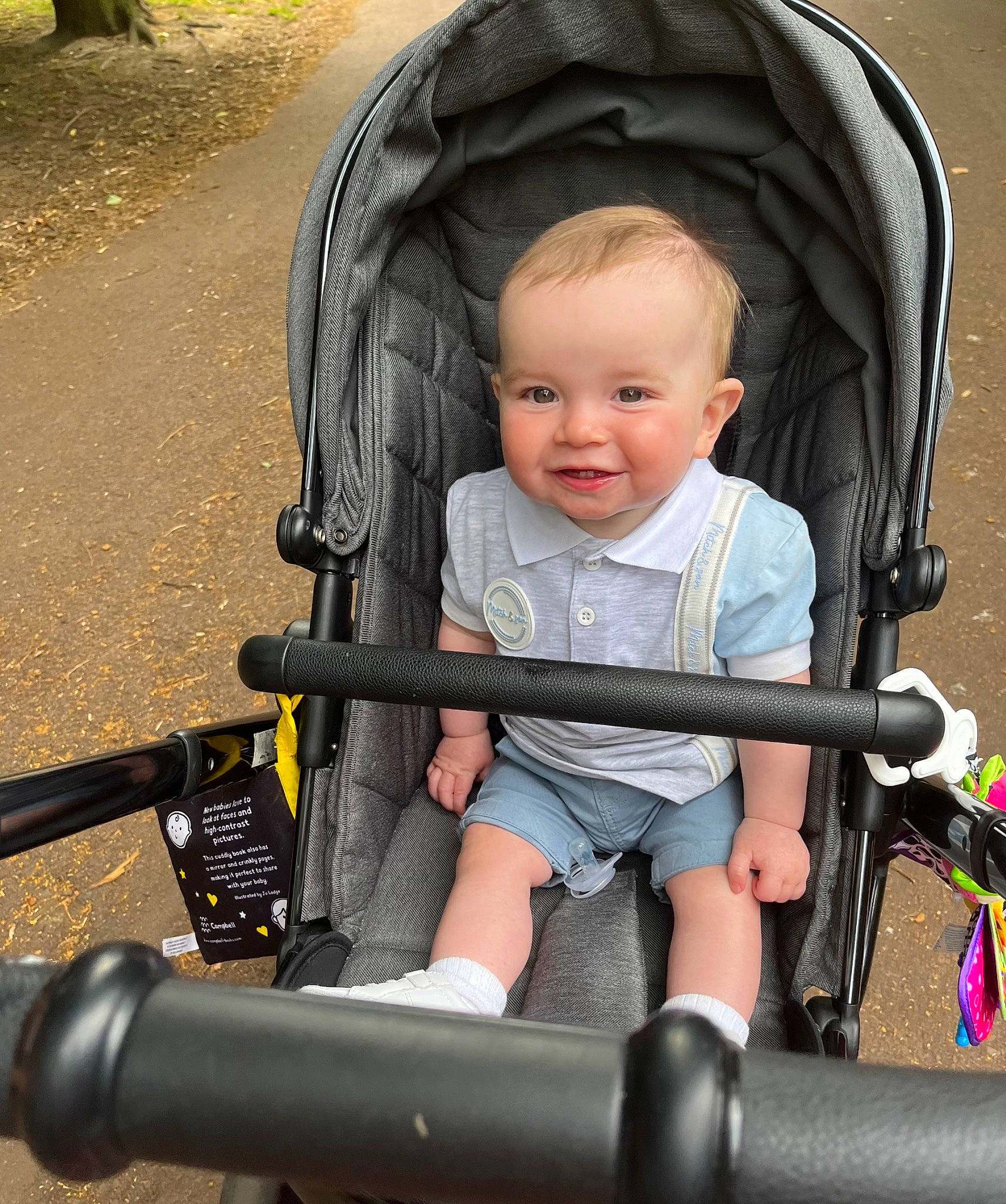 Blair is registered to the contest to win money with this photo: baby, baby_carriage, baby_products, baby_toddler_clothing, beauty, black, child, comfort, eye, facial_expression, fun, human_body, human_leg, joy, lap, person, plant, sitting, smile, tire