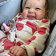 Merrilynn joined the competition — help win amazing prizes! baby, infant, smiling, car_seat, onesie, heart_pattern, pacifier, clip, hand, face, cheeks, happy, cute, child, clothing, fabric, seat, indoor, portrait, closeup