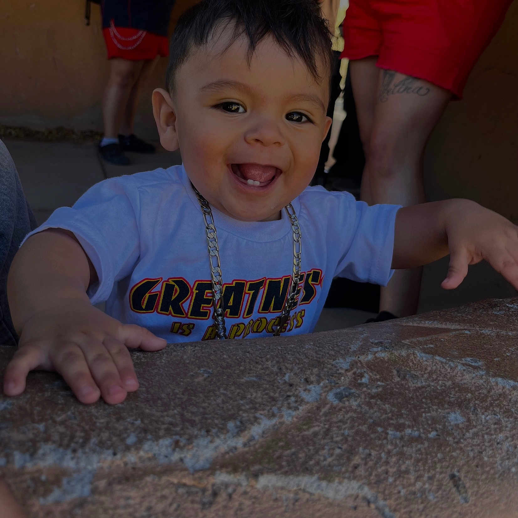 Axel joined the competition — help win amazing prizes! toddler, child, smiling, happy, face, person, necklace, clothing, tshirt, hand, stone_surface, outdoor, people, legs, shorts, tattoo, casual, background, portrait, daylight