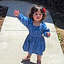 toddler, child, blue_dress, red_flower, outdoor, sidewalk, shadow, sunlight, standing, person, cute, hair, smiling, happy, young, baby_shoes, nature, daylight, expression, casual