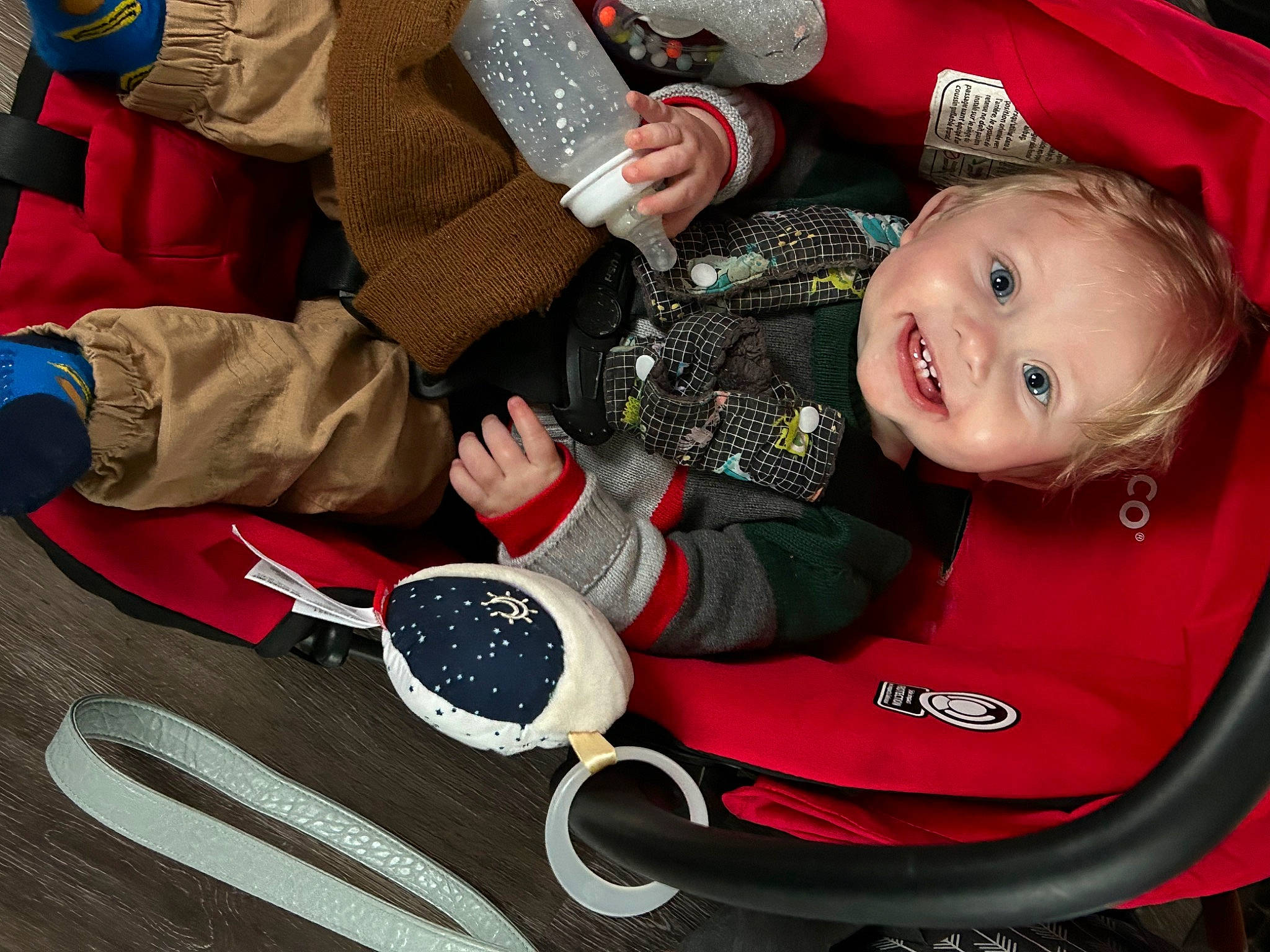 Jace is registered to the contest to win money with this photo: baby, baby_carriage, baby_products, baby_toddler_clothing, carmine, chair, child, comfort, event, eyewear, fun, happy, joy, lap, pattern, person, red, sitting, sleeve, smile