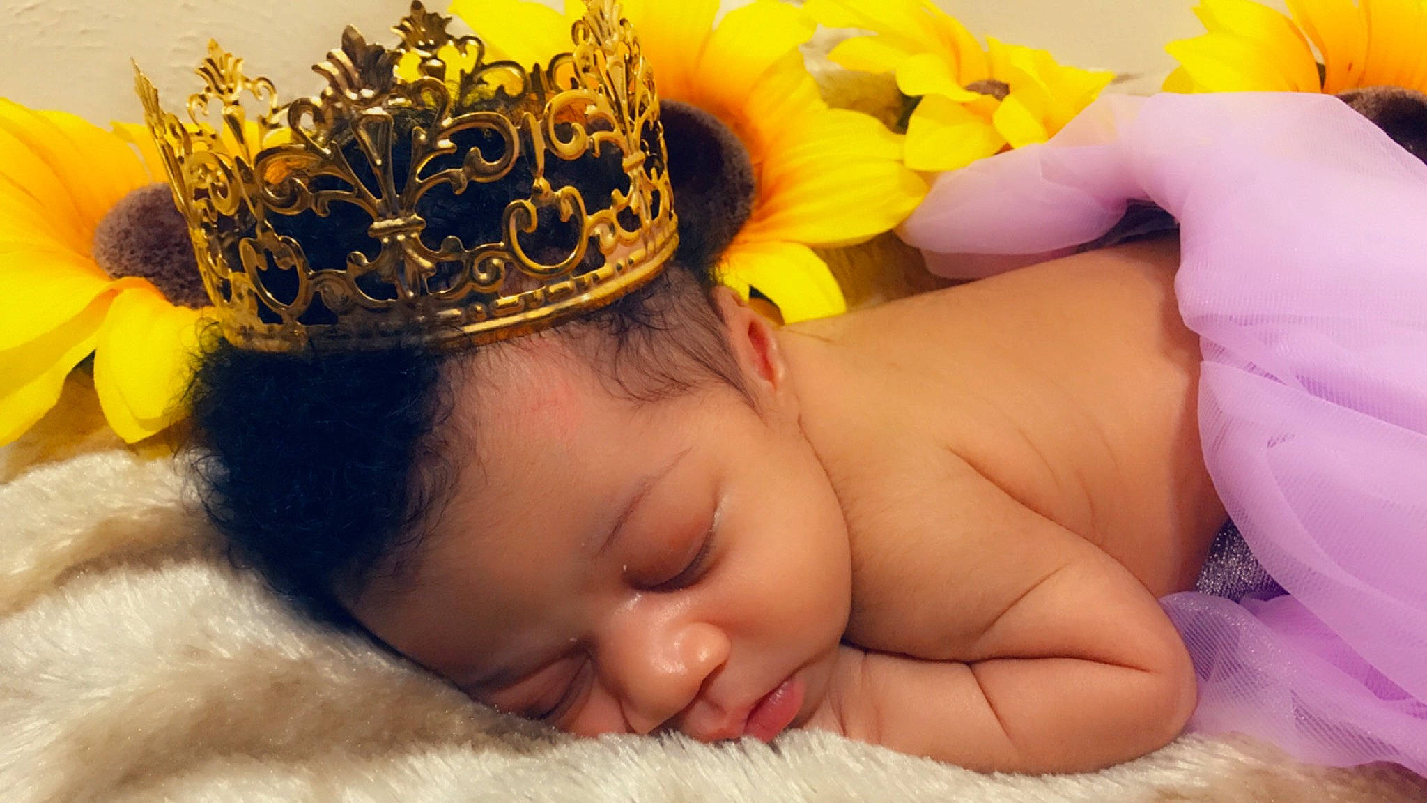 Krissy is registered to the contest to win money with this photo: baby, baby_sleeping, child, crown, fashion_accessory, finger, hair_accessory, head, headband, headgear, headpiece, nap, person, photography, plant, skin, sleep, toddler, yellow