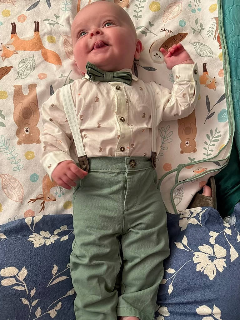 Lincoln joined the competition — help win amazing prizes! animal_print, baby, bear, blanket, bow_tie, child, clothing, cute, deer, fox, indoor, infant, leaf_pattern, lying_down, pants, playful, shirt, smiling, suspenders, tongue_out