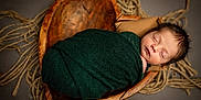 Luke joined the competition — help win amazing prizes! newborn, baby, sleeping, swaddled, blanket, wooden_bowl, ropes, cozy, portrait, infant, cute, peaceful, wrapped, head, face, indoors, warm, soft_light, resting, child