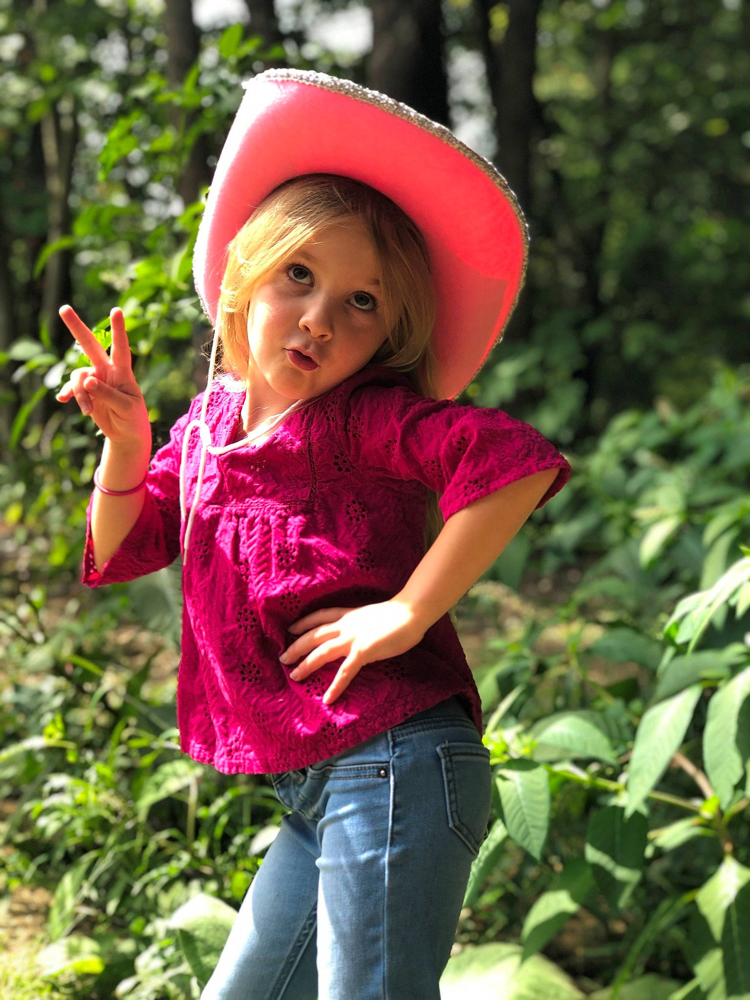 Mackinley joined the competition — help win amazing prizes! botany, child, child_model, fashion_accessory, happy, hat, headgear, jungle, leaf, magenta, people_in_nature, person, photography, pink, plant, play, smile, sun_hat, terrestrial_plant, toddler