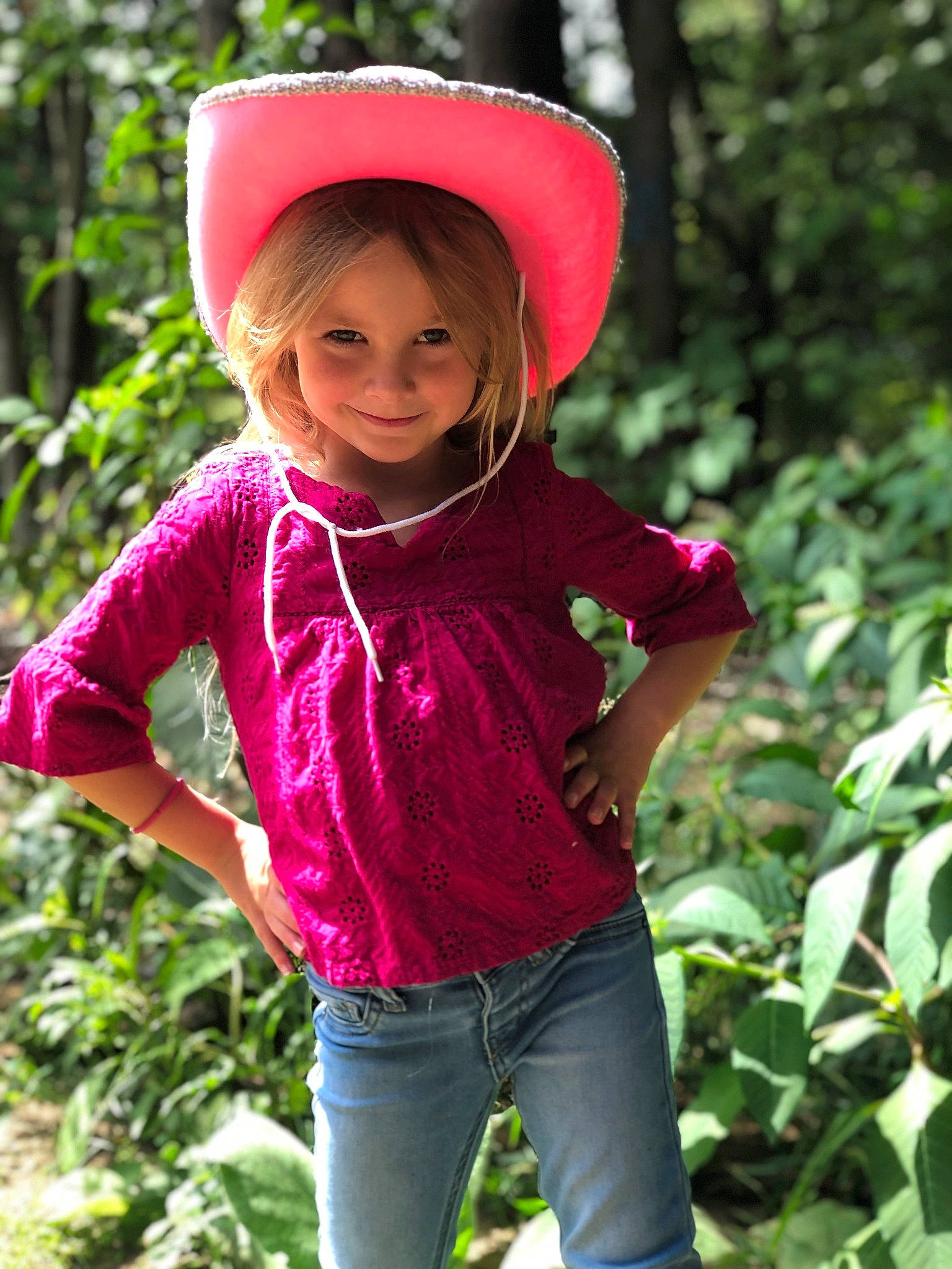 Mackinley is registered to the contest to win money with this photo: botany, cap, child, child_model, fashion_accessory, hat, headgear, joy, leisure, magenta, outerwear, person, photography, pink, plant, play, sleeve, smile, terrestrial_plant, toddler