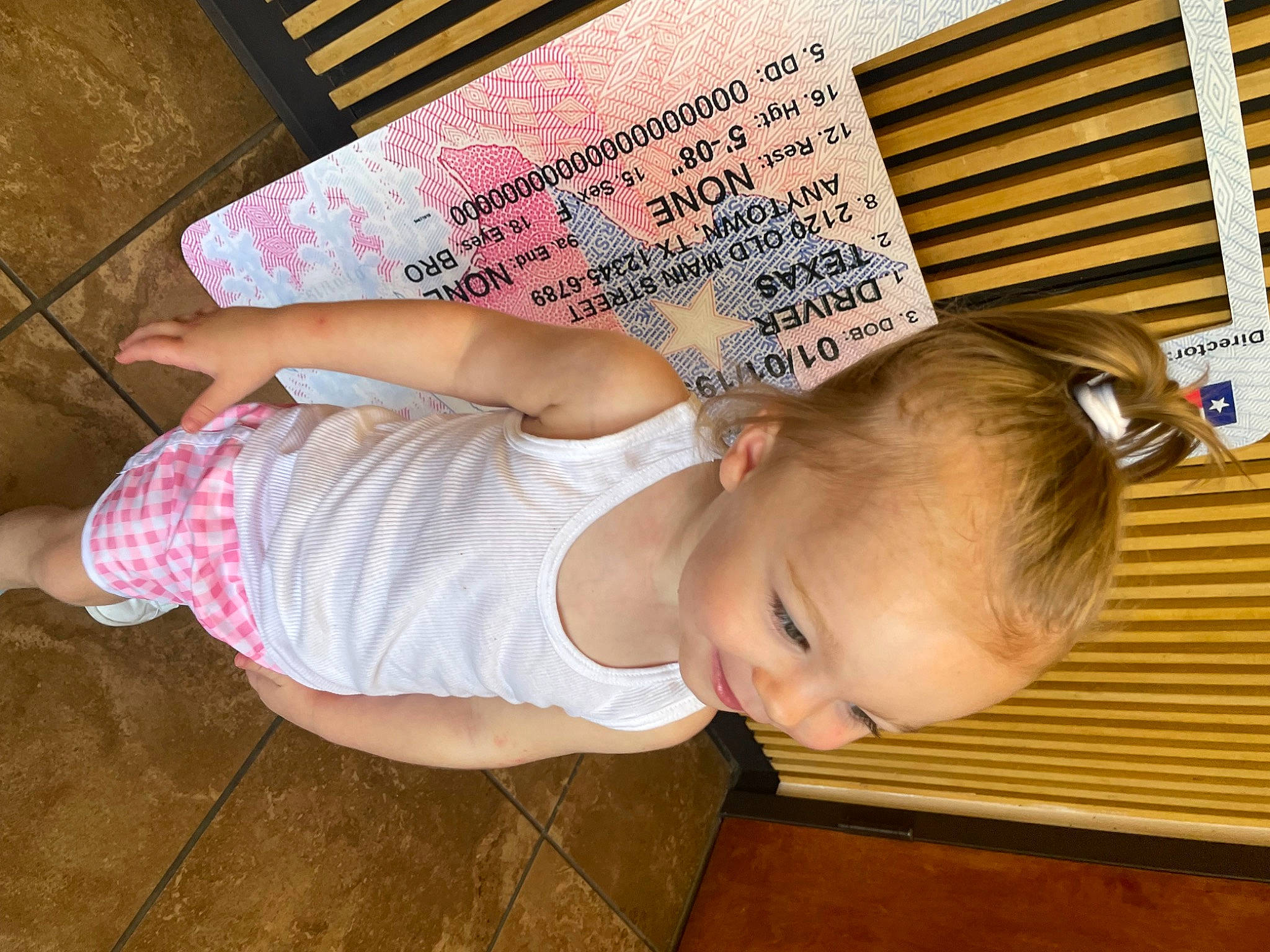 Brinley is registered to the contest to win money with this photo: baby, baby_products, baby_safety, baby_toddler_clothing, cheek, child, elbow, flooring, foot, fun, happy, hardwood, human_leg, person, room, sitting, thigh, thumb, toddler, wood