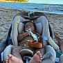 Izaric a rejoint le concours — aidez-le/la à gagner de superbes lots ! baby, car_seat, beach, pacifier, toy, sand, ocean, water, trees, foot, relaxation, sleeping, child, infant, sunlight, nature, outdoor, vacation, summer, peaceful