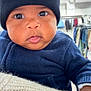 baby, child, face, headwear, hat, beanie, mickey_mouse, blue_sweater, clothing, tongue_out, cute, indoor, store, blurred_background, person, skin, hand, knitwear, expression, portrait