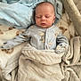 Rome is registered to the contest to win money with this photo: baby, sleeping, blanket, pajamas, infant, cozy, soft, cute, animal_print, bed, comfort, child, newborn, resting, wrapped, peaceful, toddler, face, indoors, fabric