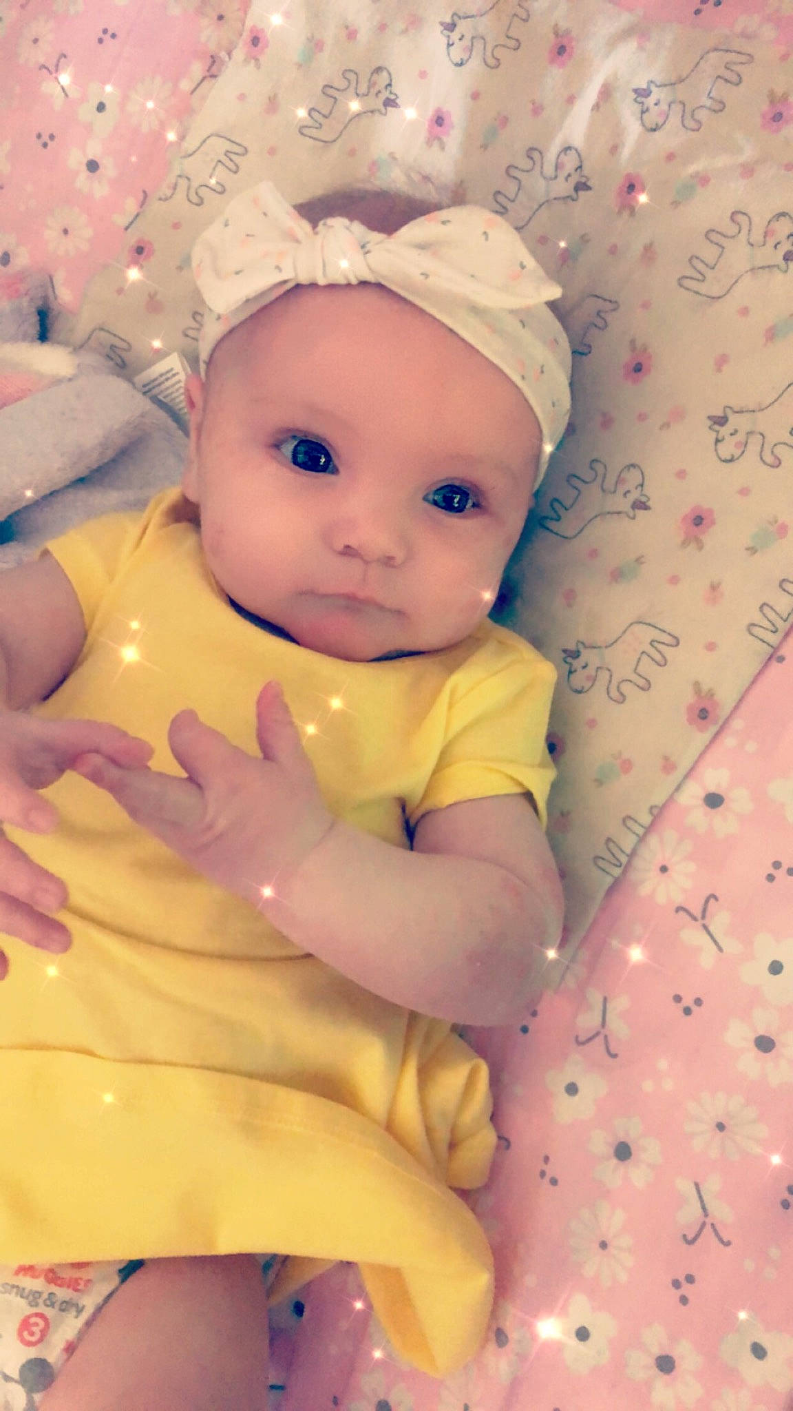 Rylynn is registered to the contest to win money with this photo: baby, baby_products, baby_toddler_clothing, cap, cheek, child, dress, fashion_accessory, hand, happy, hat, headwear, knit_cap, linens, pattern, peach, person, pink, sitting, skin