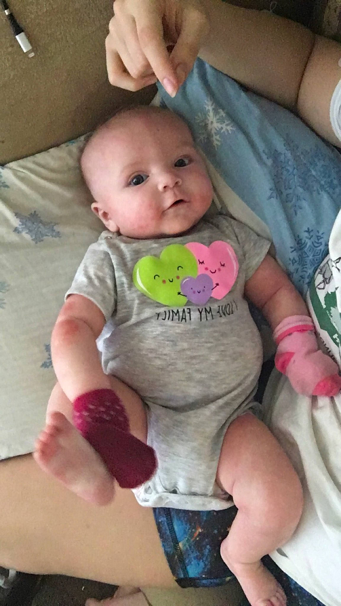 Rylynn is registered to the contest to win money with this photo: baby, baby_products, baby_toddler_clothing, cheek, child, comfort, finger, gesture, happy, linens, mouth, nose, person, pink, sitting, skin, sleeve, t_shirt, textile, thumb