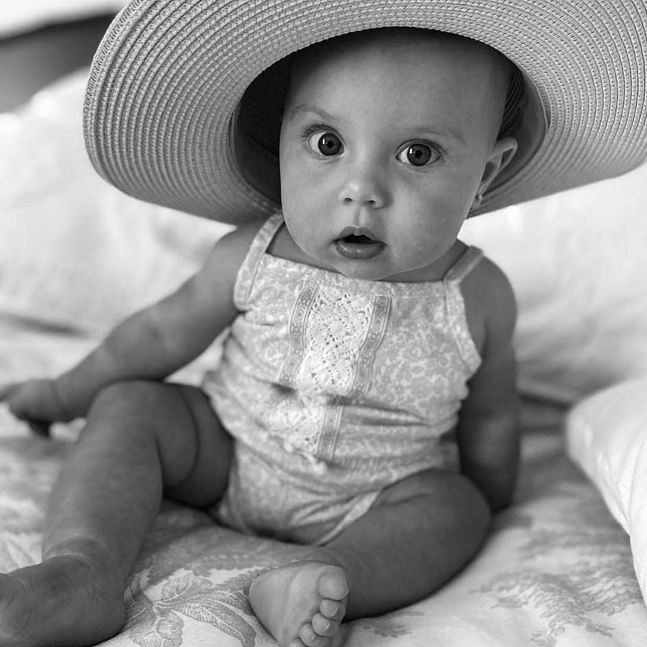 Olivia is registered to the contest to win money with this photo: baby, baby_toddler_clothing, black, black_and_white, child, eye, flash_photography, happy, hat, headgear, iris, monochrome, monochrome_photography, people, skin, standing, style, sun_hat, toddler, white