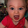 baby, child, blue_eyes, red_dress, polka_dot, ladybug, mouth_open, indoor, face, portrait, cute, infant, expression, person, skin, eyelashes, hand, table, clothing, smiling