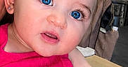 Echo is registered to the contest to win money with this photo: adult_partial, baby, blue_eyes, child, curly_hair, cute, earrings, expression, face, fan, furniture, hand, home, indoor, person, pink_bow, pink_clothing, portrait, skin, table