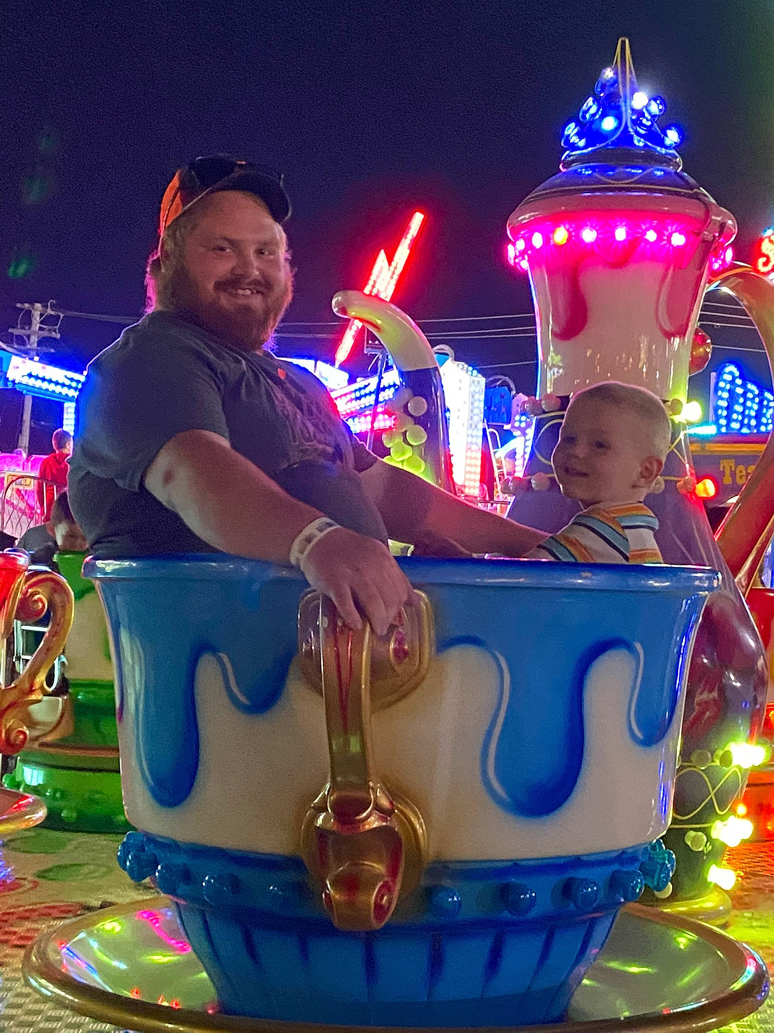 Klayton is registered to the contest to win money with this photo: amusement_park, amusement_ride, christmas, decoration, entertainment, event, festival, fun, happy, hat, holiday, joy, leisure, magenta, night, nonbuilding_structure, person, public_event, purple, recreation