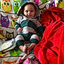 Isaiah is registered to the contest to win money with this photo: baby, infant, child, hooded_onesie, owl_blanket, colorful, red_blanket, smile, blue_eyes, sitting, feet, cozy, fabric, pattern, indoor, portrait, cute, diaper, clothing, playful