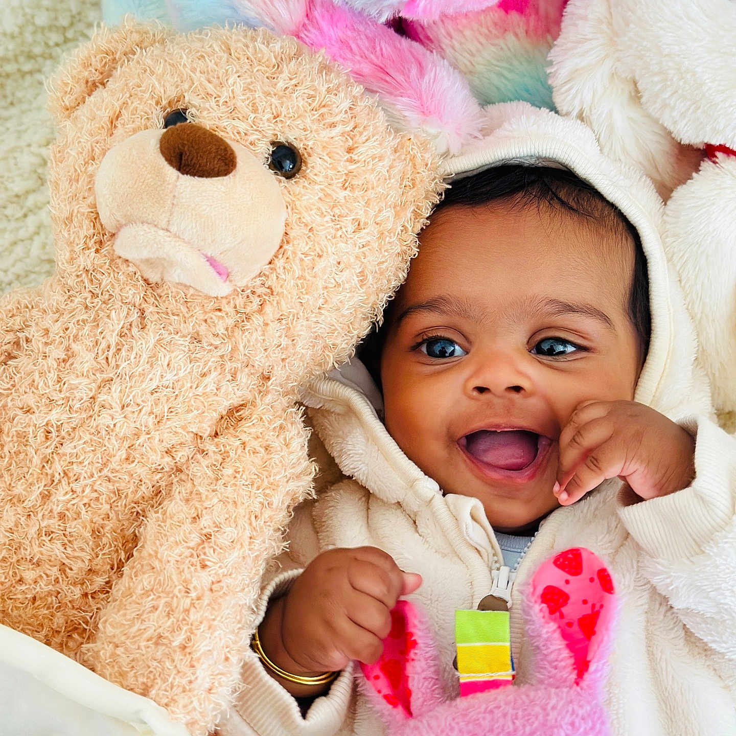 Charvi is registered to the contest to win money with this photo: baby, child, closeup, cozy, cream_color, cuddly, cute, happy, hoodie, indoor, infant, joyful, pink, playful, plush_toy, portrait, smiling, soft_toys, teddy_bear, warm