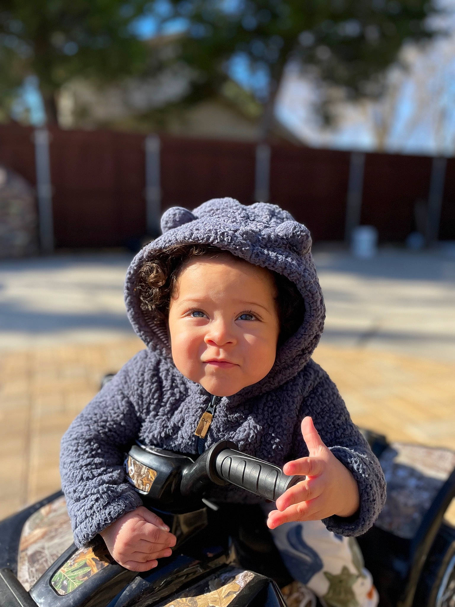 Alejandro joined the competition — help win amazing prizes! baby, cap, child, facial_expression, fun, grass, happy, headwear, helmet, jacket, person, personal_protective_equipment, photograph, plant, recreation, sitting, skin, smile, toddler, travel