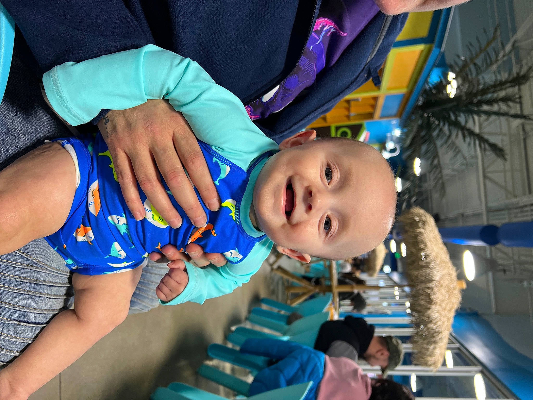 Rowen is registered to the contest to win money with this photo: baby, baby_toddler_clothing, blue, child, elbow, electric_blue, event, fun, gesture, happy, human_leg, leisure, mouth, nail, person, smile, thigh, thumb, toddler, water