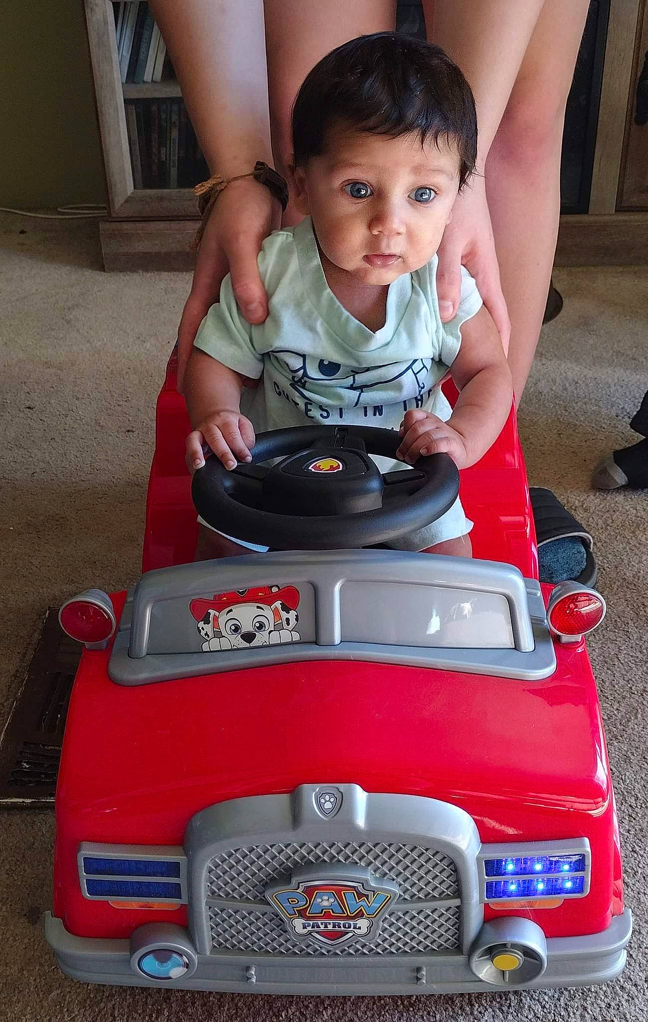 Isaac is registered to the contest to win money with this photo: auto_part, automotive_design, automotive_exterior, automotive_lighting, automotive_wheel_system, baby, baby_carriage, bumper, grille, happy, head, headlamp, hood, light, motor_vehicle, person, red, riding_toy, toddler, toy