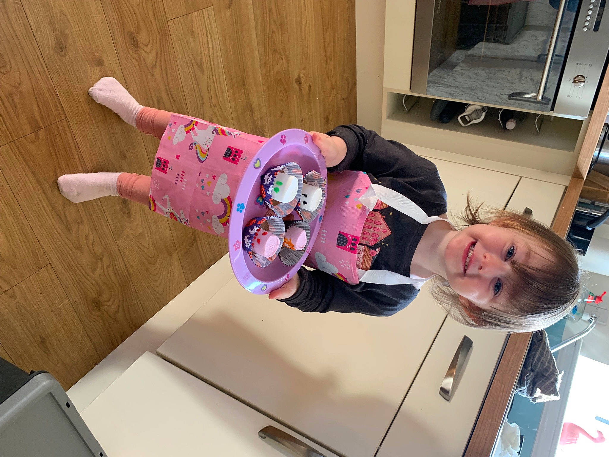 Lily Tiger-rose is registered to the contest to win money with this photo: baby, baby_toddler_clothing, child, comfort, joy, laundry_room, magenta, person, pink, room, sleeve, smile, t_shirt, toddler, vehicle_door, wood