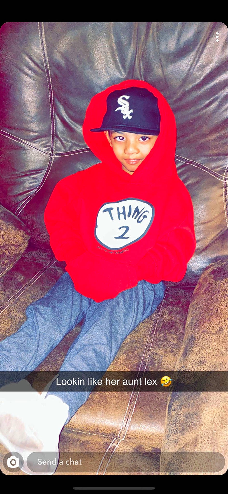 Hailee is registered to the contest to win money with this photo: baseball_cap, beanie, cap, carmine, comfort, cool, electric_blue, flash_photography, font, fun, headwear, hood, hoodie, joy, magenta, person, photo_caption, recreation, red, sitting