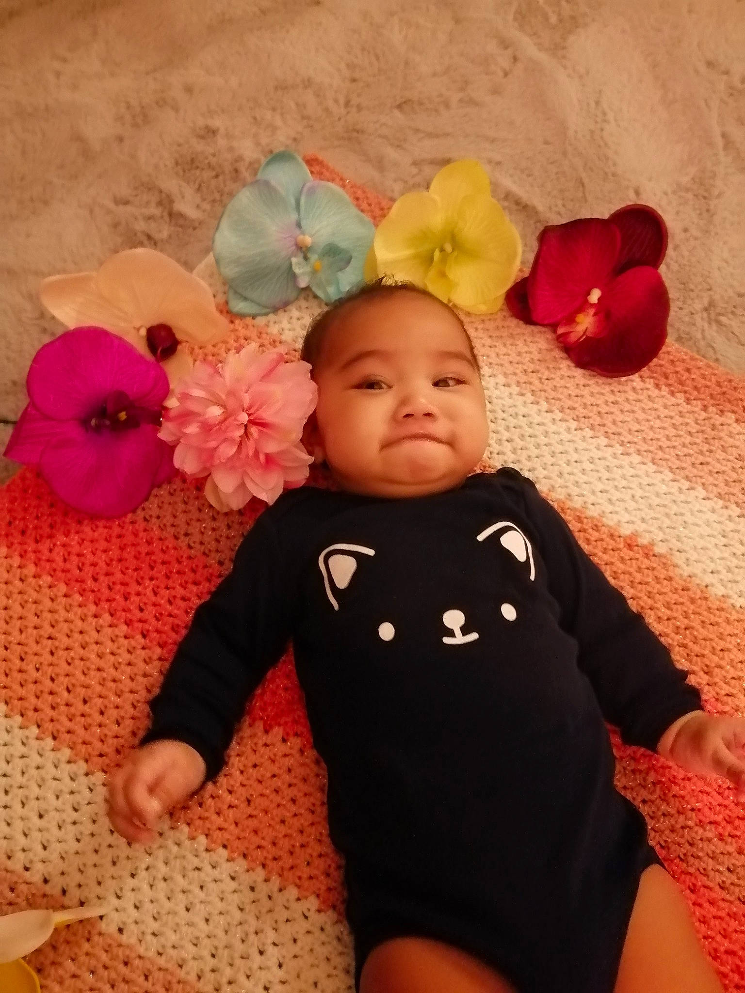 Rumatahina a rejoint le concours — aidez-le/la à gagner de superbes lots ! baby, baby_toddler_clothing, cheek, comfort, eye, facial_expression, finger, flooring, head, headgear, leaf, mammal, person, petal, pink, plant, product, skin, sleeve, textile