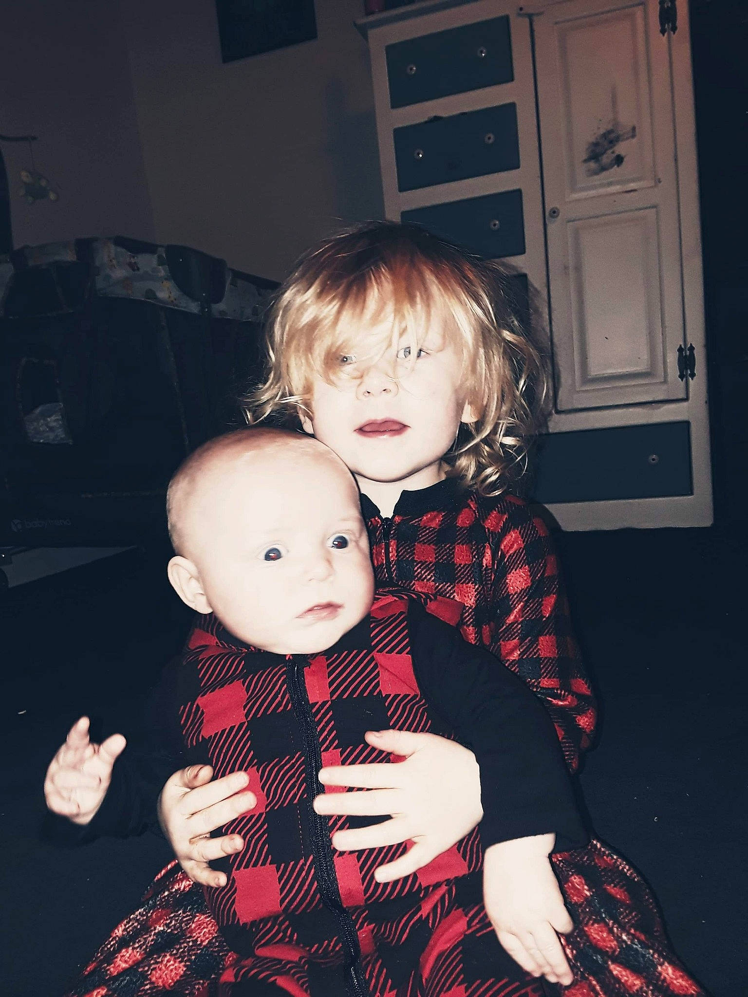 Houston is registered to the contest to win money with this photo: baby_toddler_clothing, child, door, facial_expression, finger, flash_photography, hand, happy, head, lap, monochrome, pattern, person, plaid, sitting, sleeve, snapshot, stuffed_toy, tartan, toddler